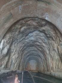 A child gazes into a mysterious tunnel while on a boat, highlighting an adventurous exploration experience. Perfect for those seeking unique underwater adventures.