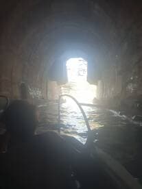 A captivating view from inside a boat as it navigates through a scenic cave, showcasing the adventure of exploring hidden waterways.