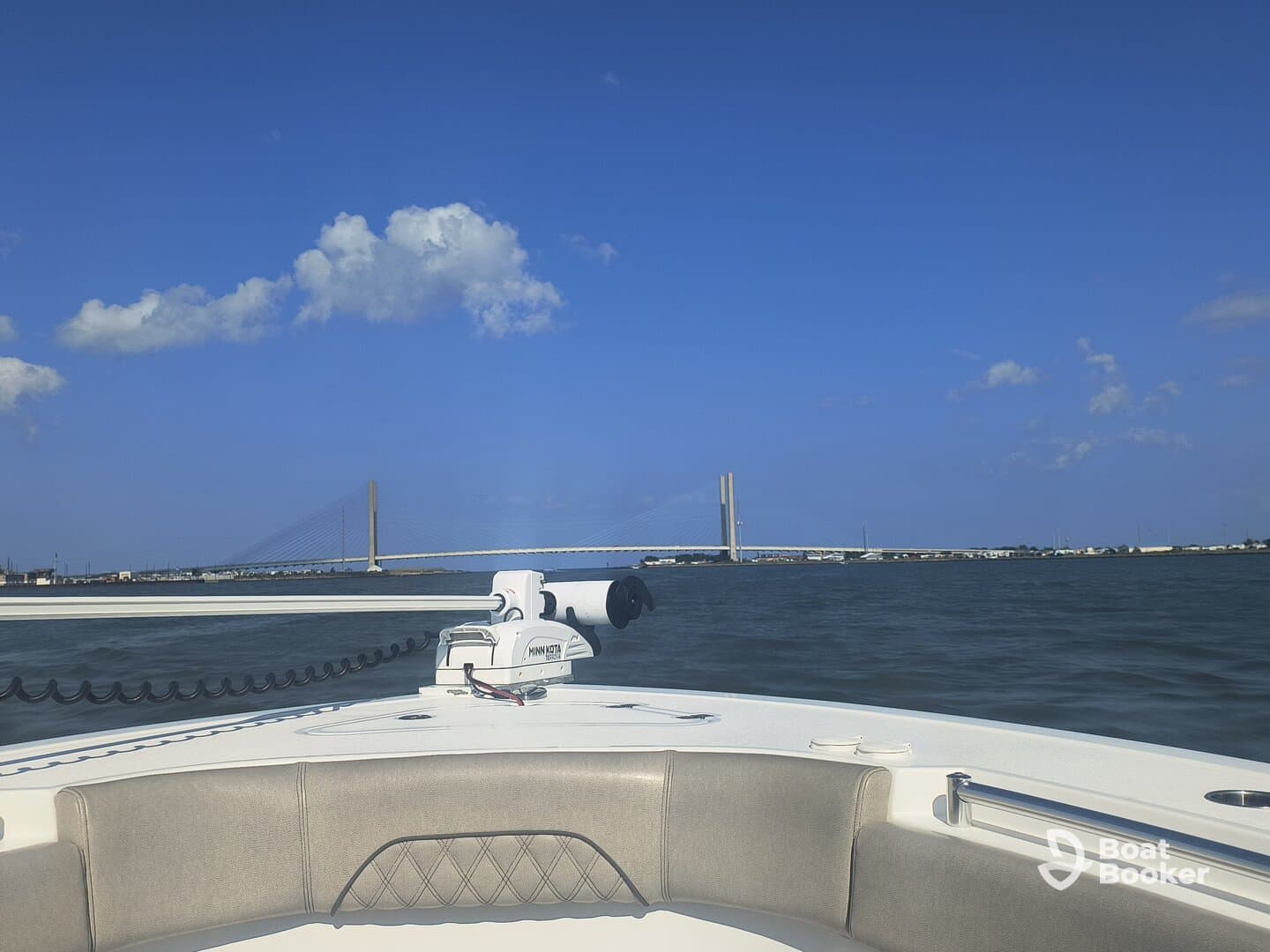 A scenic view from the deck of a boat, showcasing a bridge against a clear blue sky — perfect for capturing the essence of a day on the water.