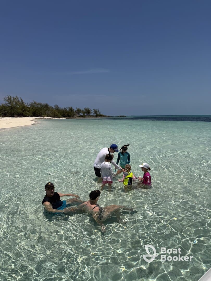 A joyful family enjoys a fun day at the beach, playing in the shallow waters and creating lasting memories together.