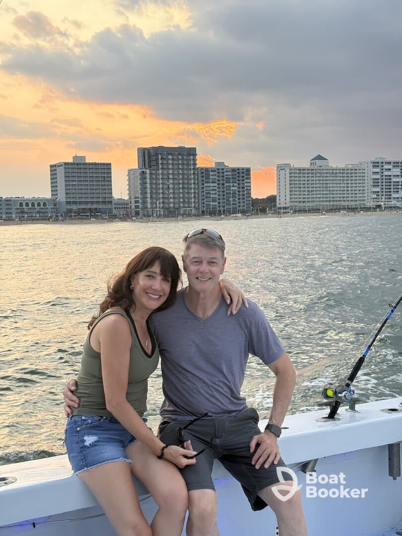 A couple enjoys a romantic moment on a fishing boat at sunset, capturing the essence of a perfect day on the water.