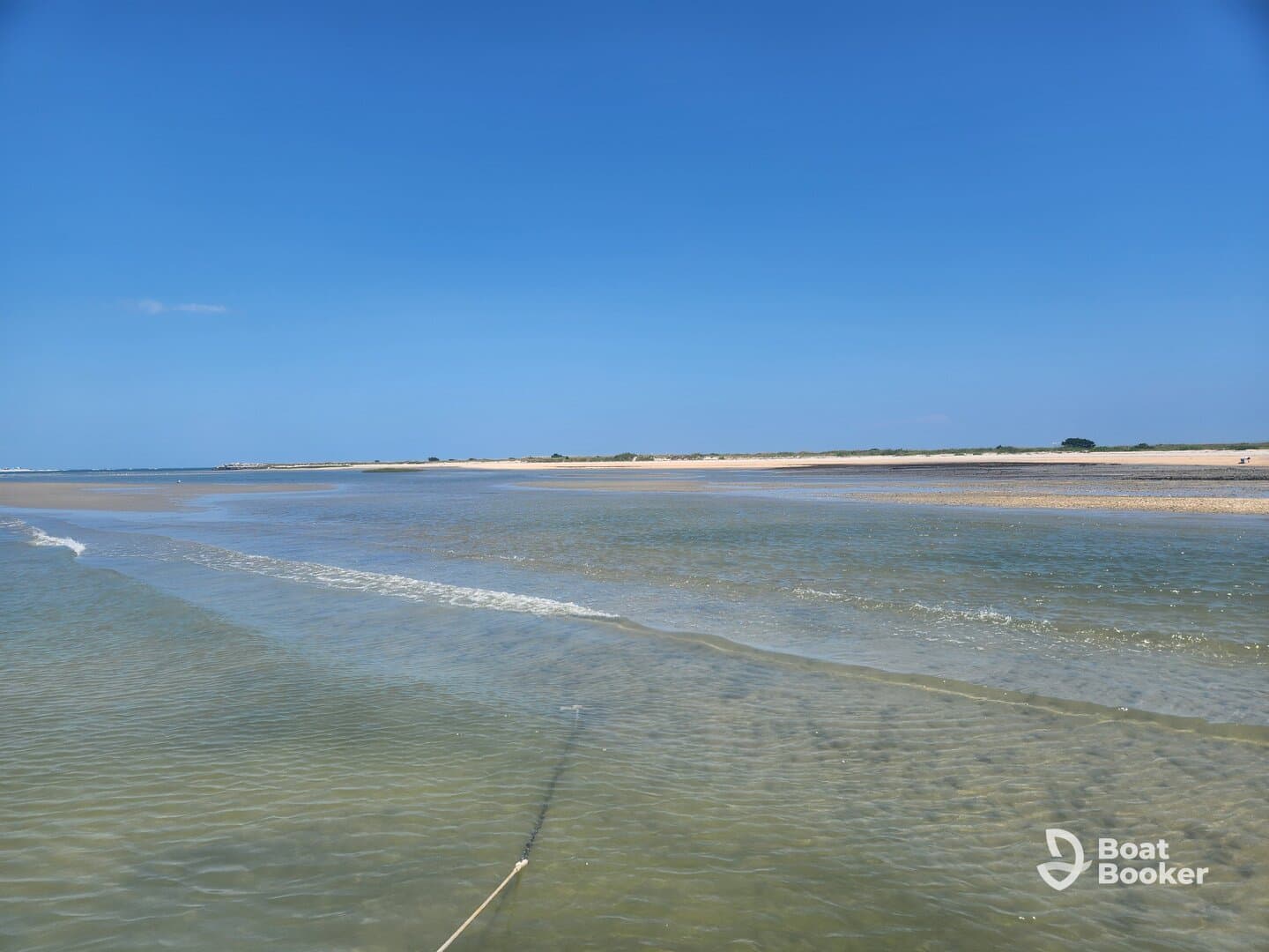 A scenic view of a shallow water area with a sandy beach in the background, ideal for exploring coastal landscapes.