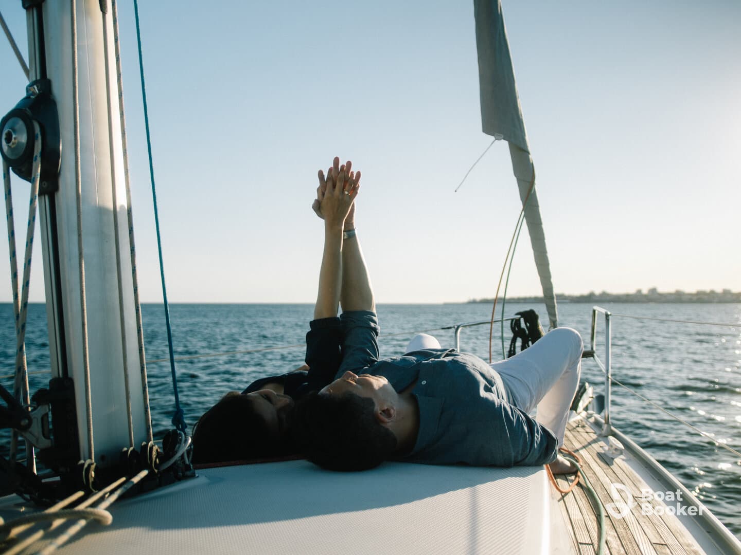 A couple enjoys a romantic moment on the deck of a sailboat, capturing the essence of love and adventure on the open water.