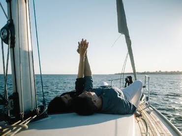 A couple enjoys a romantic moment on the deck of a sailboat, capturing the essence of love and adventure on the open water.