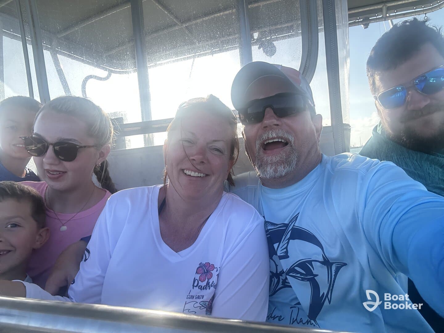 A joyful family captures a selfie aboard a boat, showcasing smiles and togetherness during their aquatic adventure.