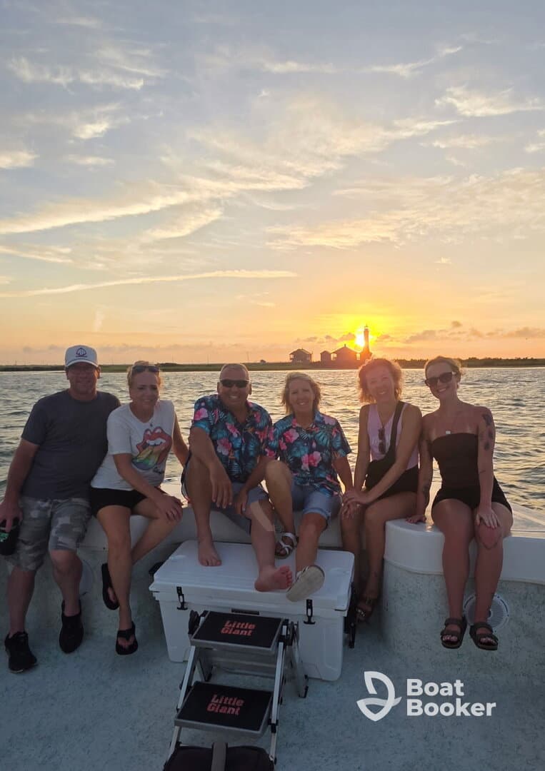 A cheerful group of friends enjoys a sunset on the water, capturing the perfect moment for a memorable boat trip.