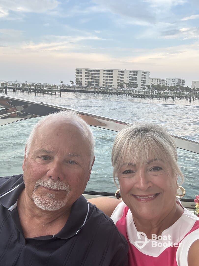 A happy couple enjoys a scenic moment on their boat, capturing the joy of their waterfront experience against a beautiful backdrop.
