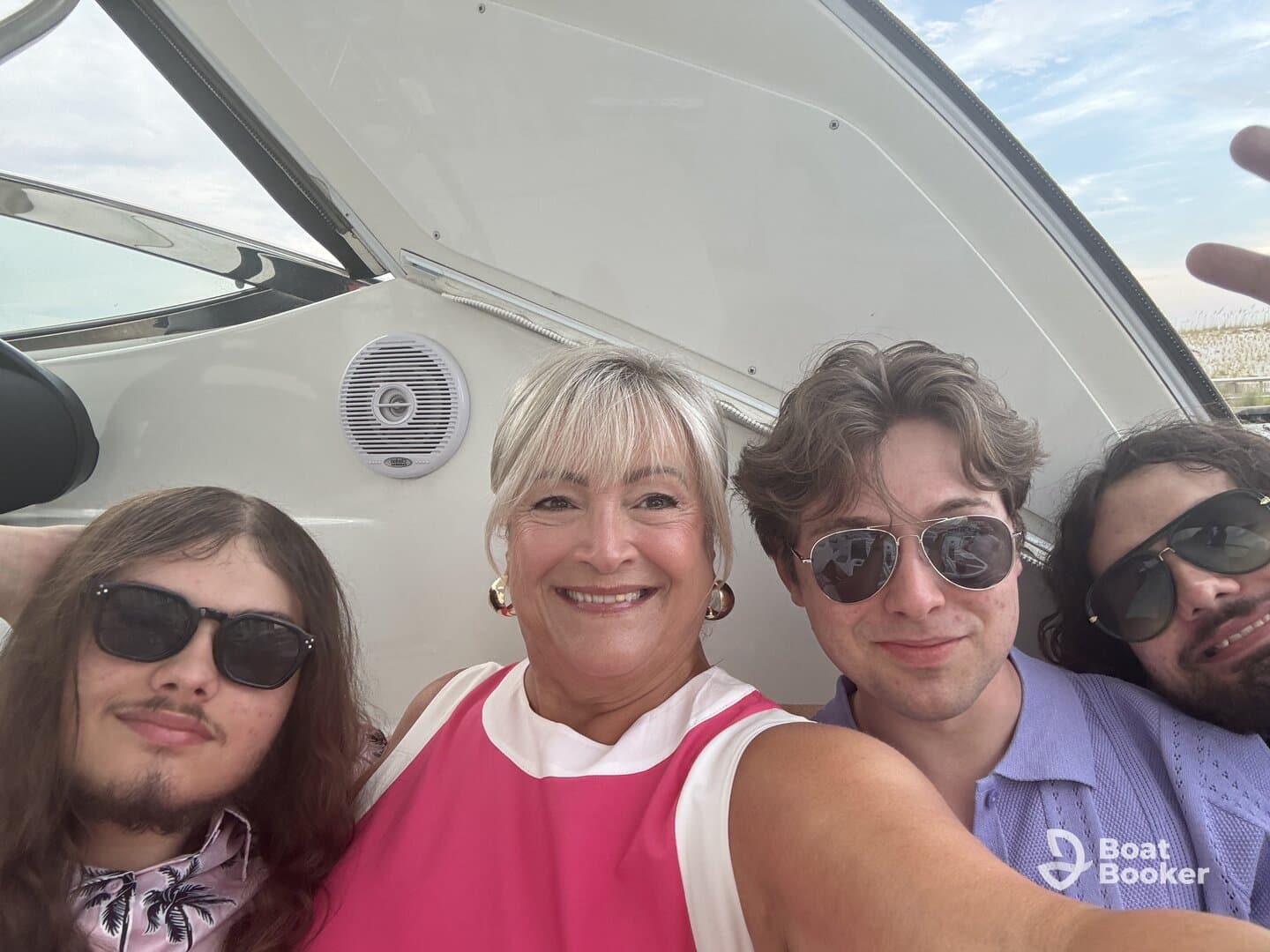 A cheerful group enjoys a fun moment on a boat, capturing a selfie that showcases their excitement and camaraderie on the water.