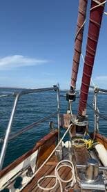 A beautiful view of a sailboat's deck with ropes and sails, showcasing the craftsmanship and elegance of sailing on open waters.