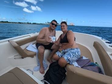 A couple enjoys refreshing cocktails on a boat, capturing the essence of a perfect day on the water. Ideal for romantic getaways or fun outings with friends.