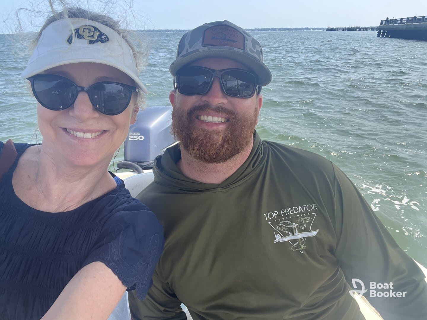 A cheerful couple enjoys a sunny day on the water, capturing a fun selfie aboard their boat — perfect for adventure seekers and boating enthusiasts.