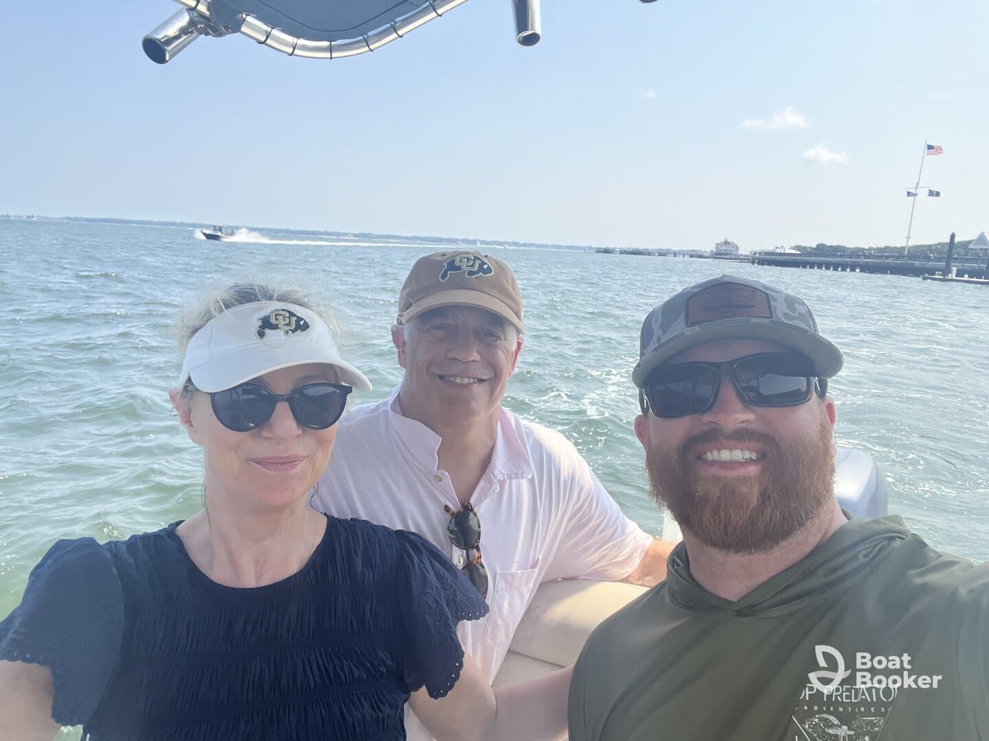 A cheerful group of friends enjoys a day on the water, capturing smiles and good times aboard their boat.