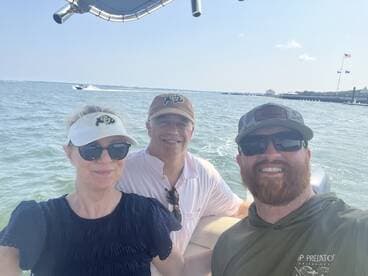A cheerful group of friends enjoys a day on the water, capturing smiles and good times aboard their boat.