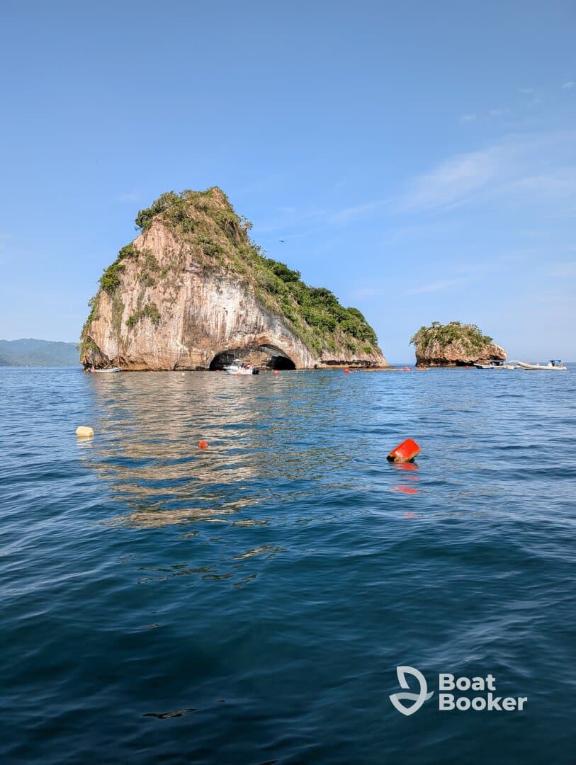 A stunning view of rocky islands rising from the clear blue waters, showcasing the natural beauty of the coastline — perfect for scenic boat tours and exploration.