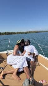 A couple shares a romantic moment on a boat, enjoying drinks and each other's company under the sun — perfect for intimate getaways or special celebrations.