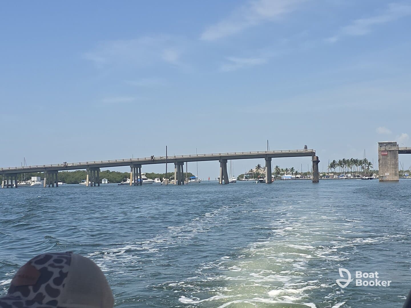 A scenic view of a bridge spanning a waterway, with various boats visible in the background — perfect for showcasing the beauty of coastal navigation.