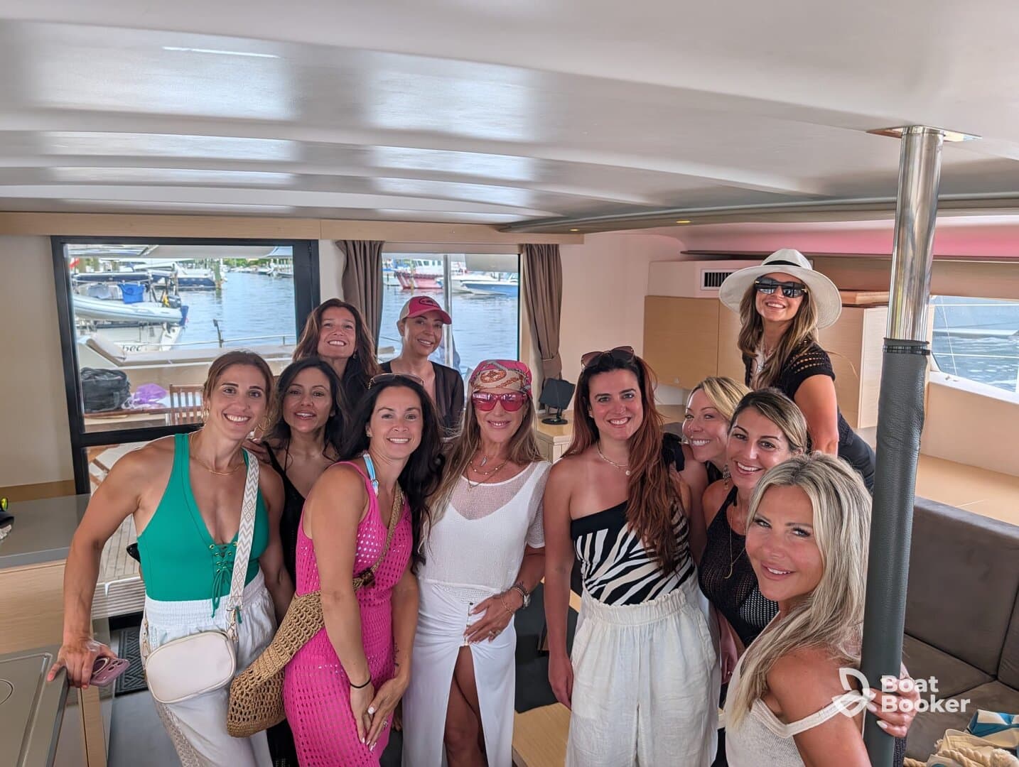 A lively group of women poses together inside a boat, capturing a moment of celebration and camaraderie — perfect for bachelorette parties or girls' trips on the water.