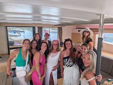 A lively group of women poses together inside a boat, capturing a moment of celebration and camaraderie — perfect for bachelorette parties or girls' trips on the water.