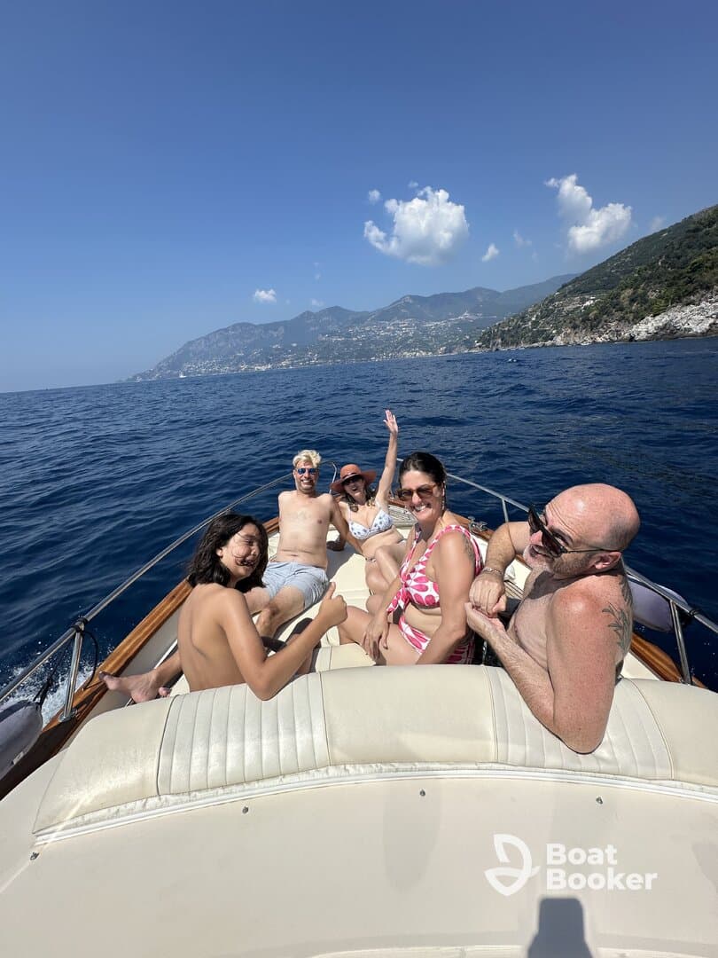 A cheerful group enjoys a sunny day on a boat, showcasing the perfect atmosphere for family fun and memorable moments on the water.