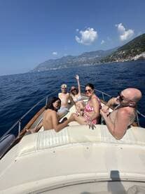 A joyful group of family members enjoys a sunny day on the boat, capturing the essence of summer fun and togetherness on the water.