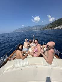 A cheerful group enjoys a sunny day on a boat, showcasing the perfect atmosphere for family fun and memorable moments on the water.