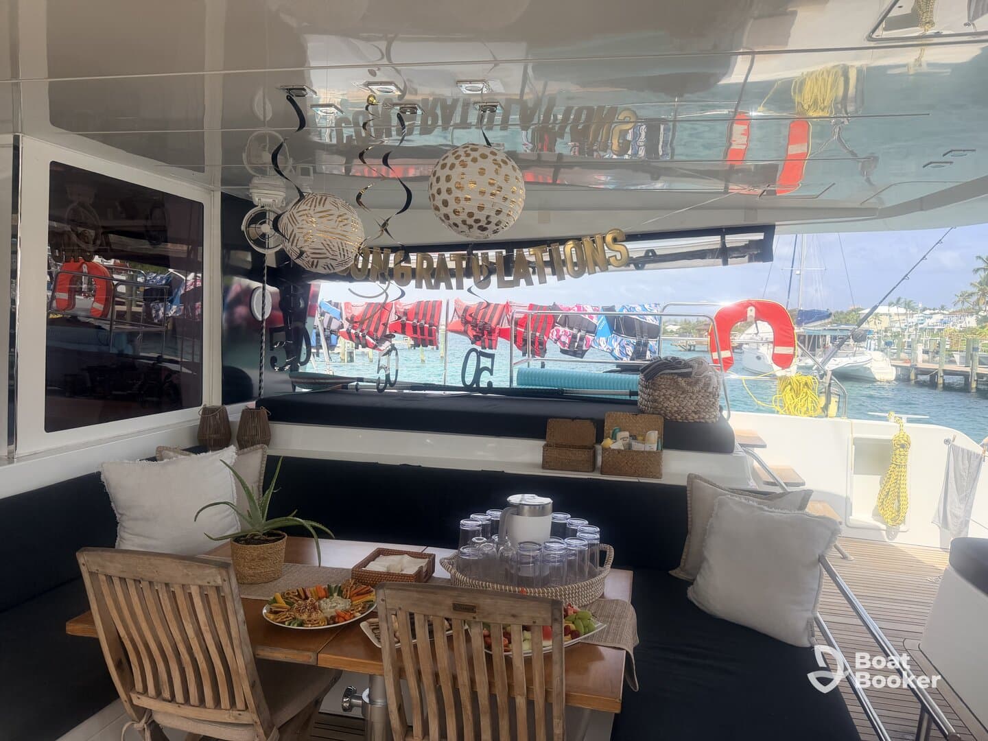 A beautifully arranged dining area inside a boat, featuring a celebratory setup with food and decorations, perfect for gatherings and special occasions on the water.