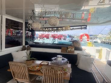 A beautifully arranged dining area inside a boat, featuring a celebratory setup with food and decorations, perfect for gatherings and special occasions on the water.