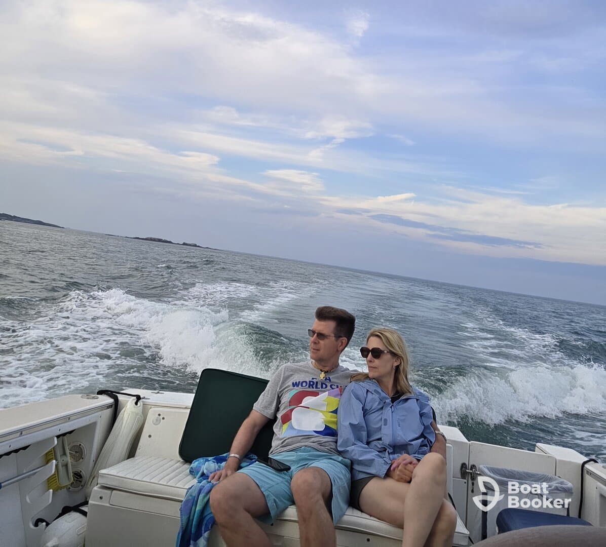 A couple enjoys a relaxing moment on a boat, taking in the scenic views while cruising on the water.