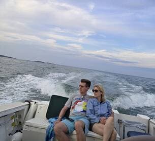 A couple enjoys a relaxing moment on a boat, taking in the scenic views while cruising on the water.