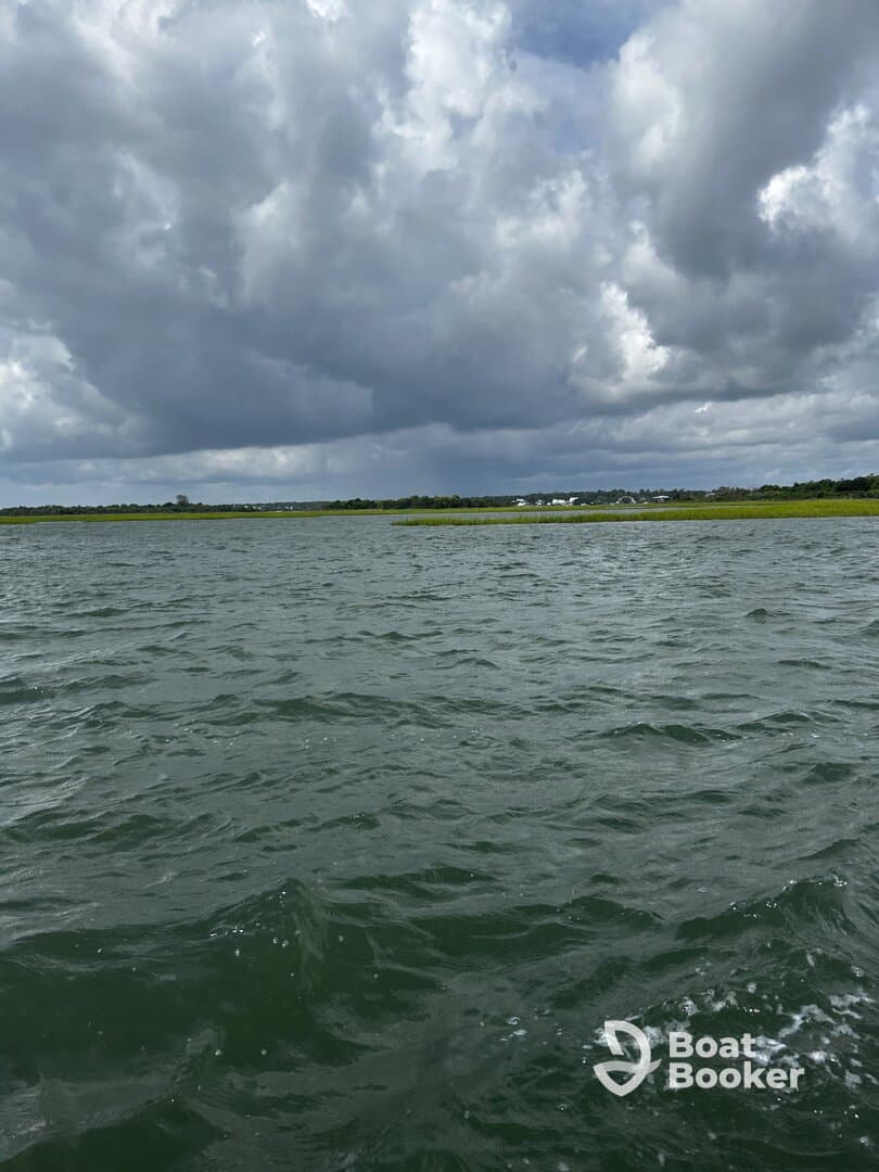 A scenic view of a waterway under a cloudy sky, with no identifiable subjects or activities.
