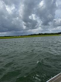 A cloudy scene over water with unclear visibility, lacking identifiable subjects or activities.