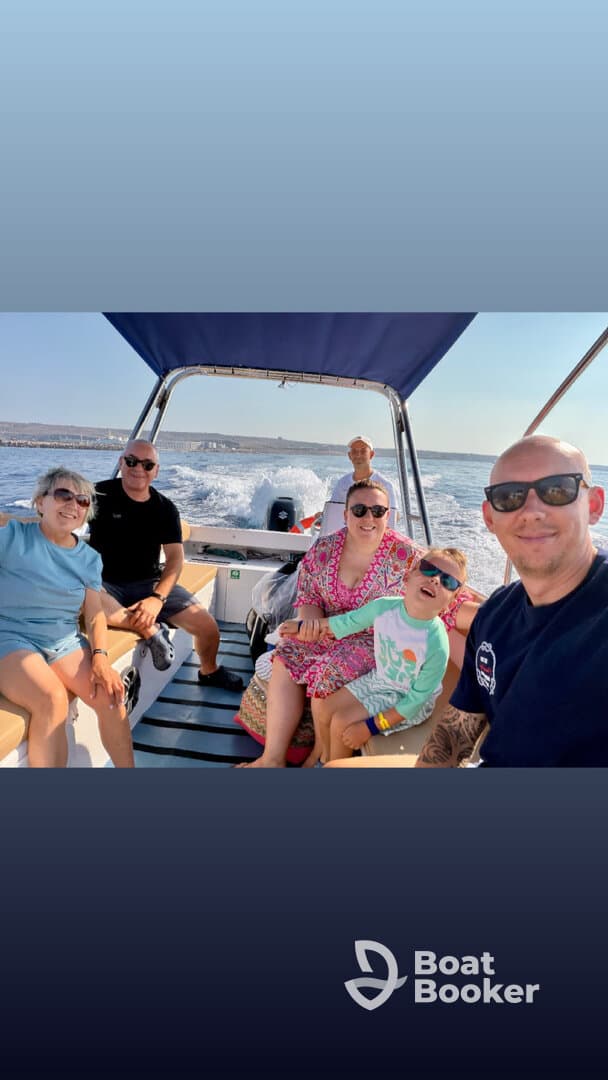 A joyful family enjoys a sunny day on a boat, capturing fun moments together — perfect for creating lasting memories on the water.