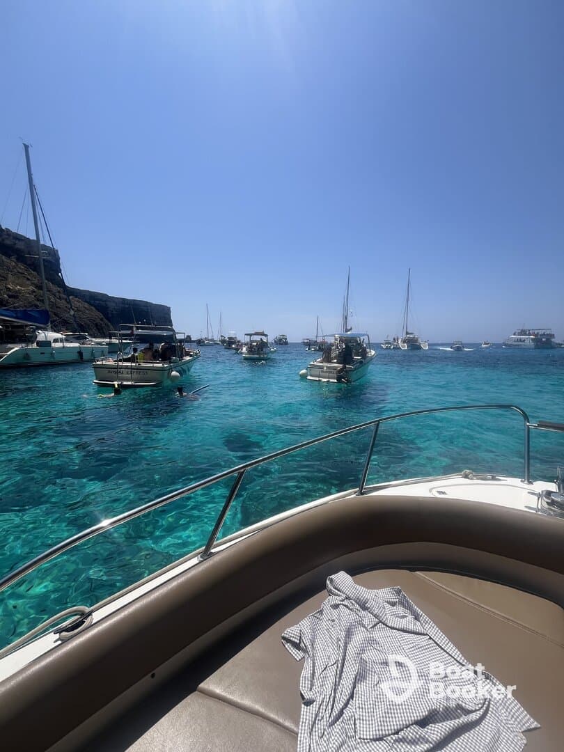 A stunning view of multiple boats anchored in crystal-clear turquoise waters, perfect for island hopping adventures and enjoying the beautiful scenery.