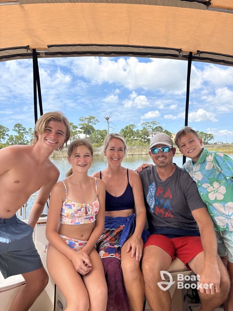 A joyful family poses together on a boat, capturing a perfect moment of fun and togetherness on the water.