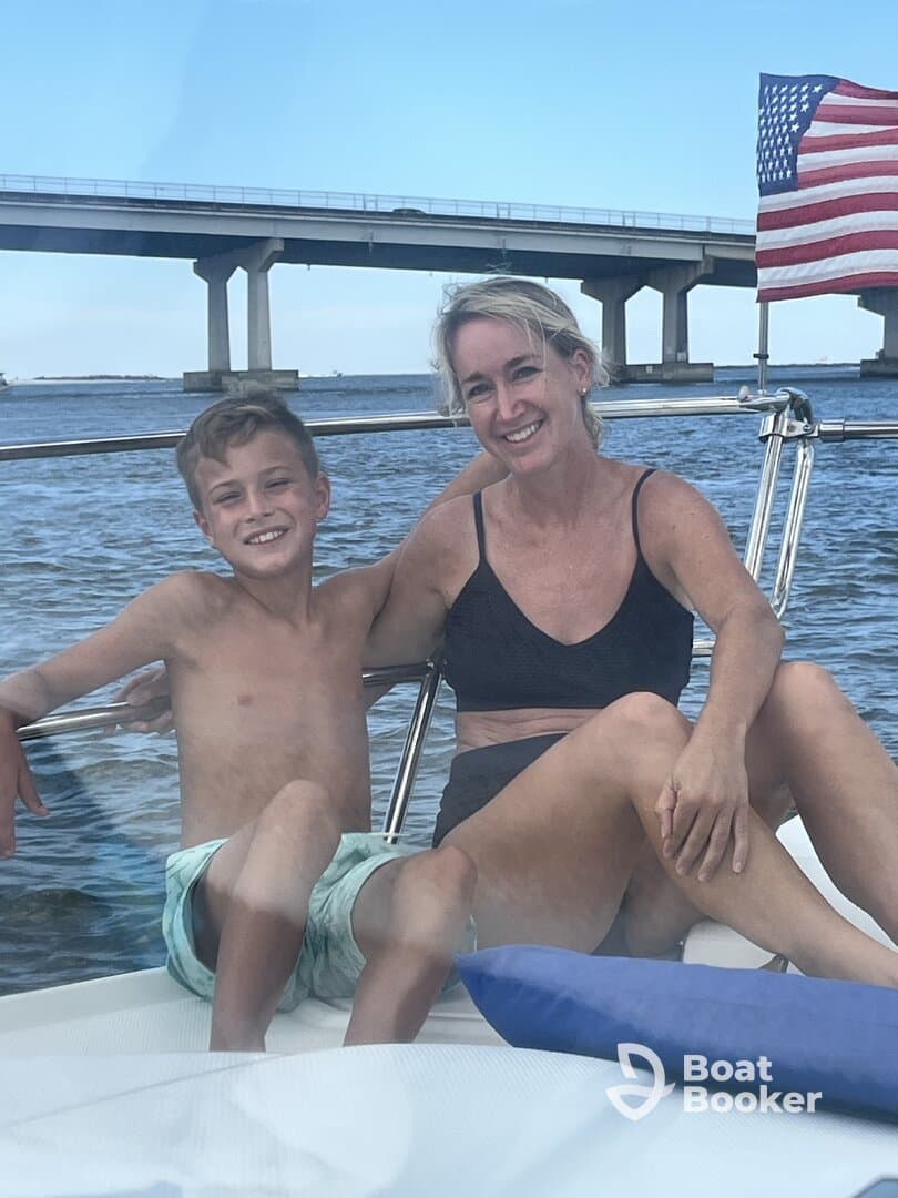 A joyful moment captured on a boat with a mother and her son, enjoying their time together on the water — perfect for family outings and summer adventures.