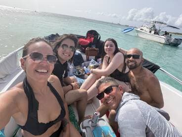 A joyful group of friends enjoys a fun day on the boat, capturing smiles and laughter under the sun — perfect for memorable outings on the water.