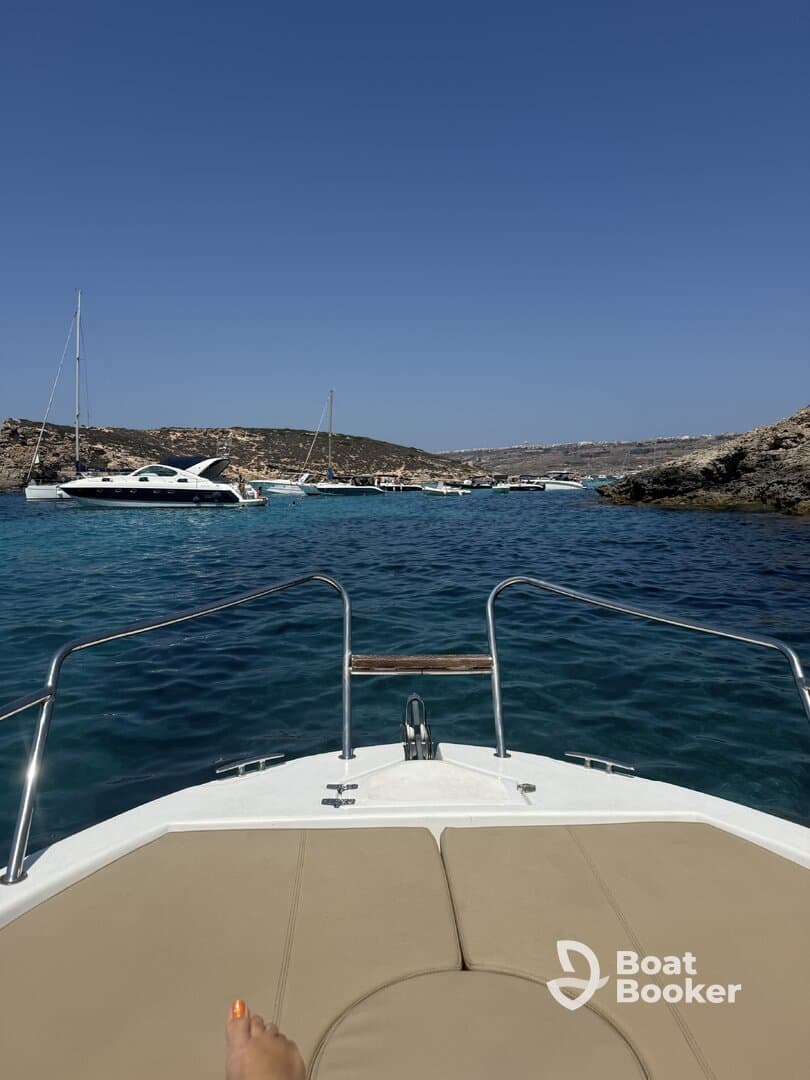 A view from the front of a boat showcasing the stunning turquoise waters and anchored vessels, perfect for a day of relaxation and exploration on the water.