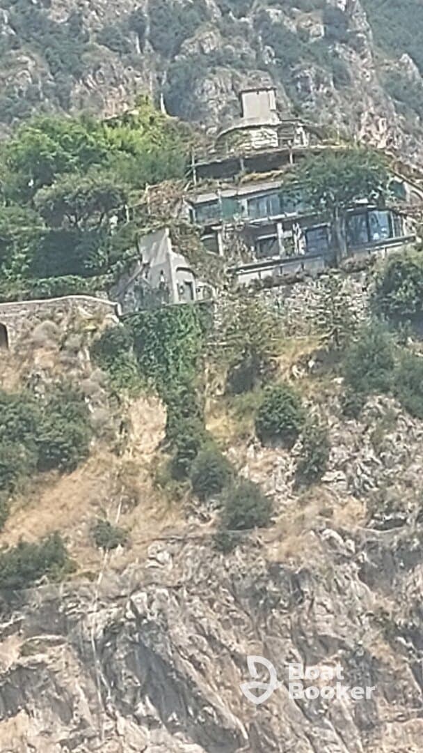 An unclear image of a structure on a hillside, lacking identifiable features or context.