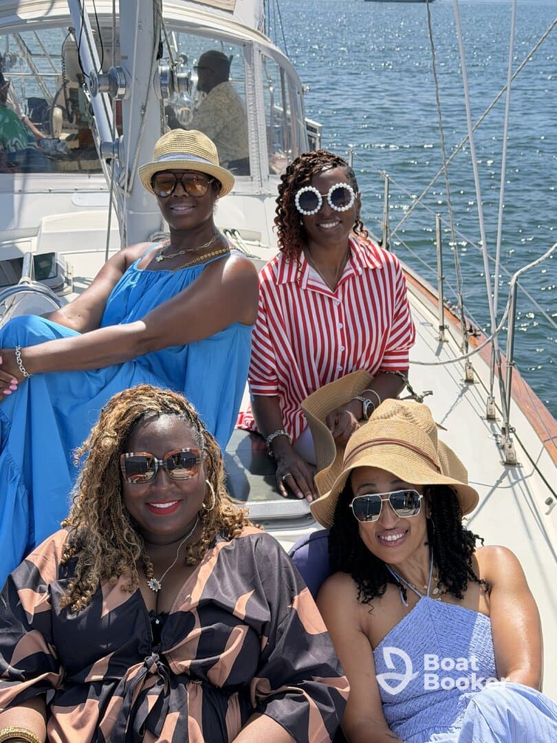 A joyful group of friends enjoys a sunny day sailing, showcasing the perfect atmosphere for celebrations and memorable outings on the water.
