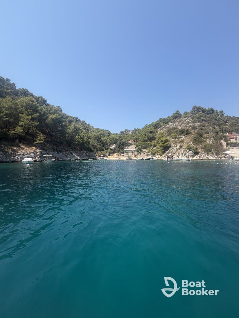 A serene view of a picturesque coastline with lush greenery and clear turquoise waters, perfect for exploring hidden harbors and enjoying nature's beauty.