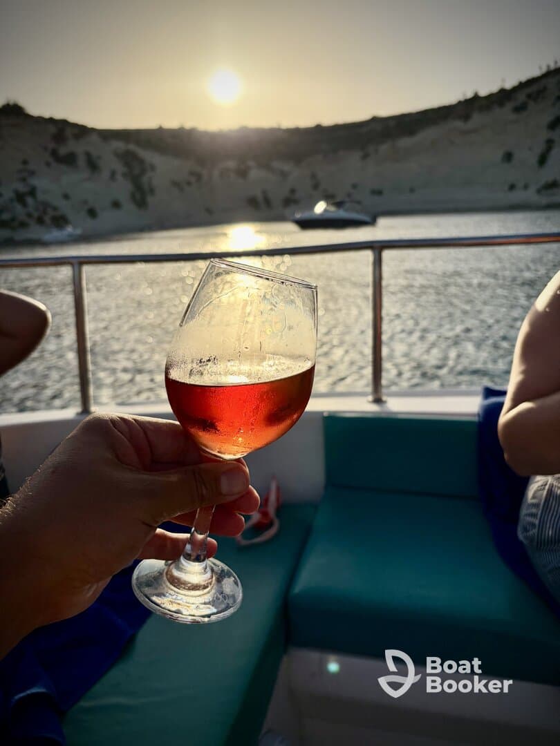 A toast with cocktails at sunset aboard a boat, capturing the essence of relaxation and celebration on the water.