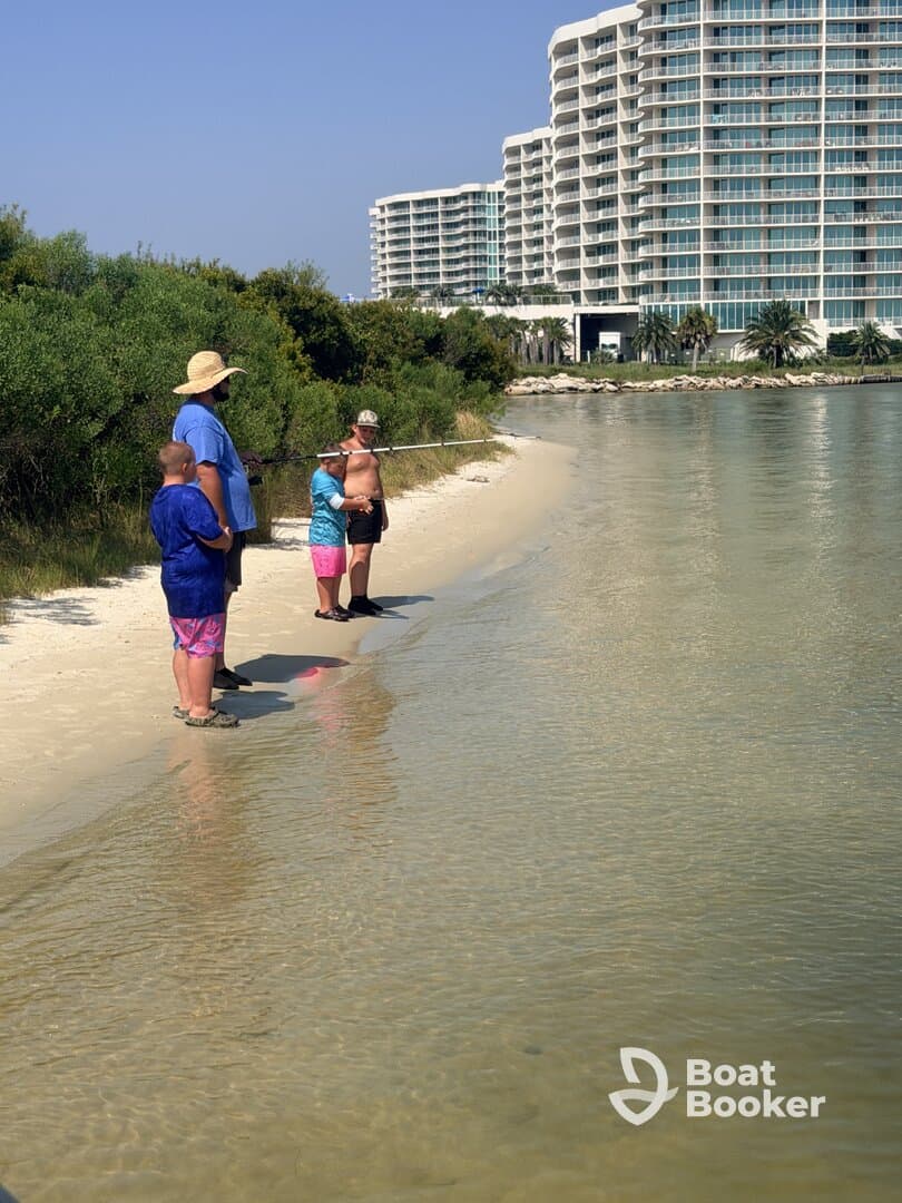 A family enjoys a day of fishing along the beach, creating lasting memories in a beautiful outdoor setting.