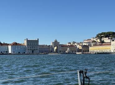 A picturesque view of the historic waterfront buildings in Lisbon, showcasing the vibrant architecture and beautiful coastline, perfect for sightseeing and exploring the city's rich culture.