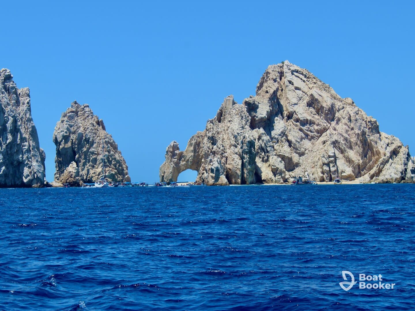 A stunning view of the iconic rock formations at Land's End in Cabo San Lucas, showcasing the natural beauty of the coastline against a vibrant blue sea.