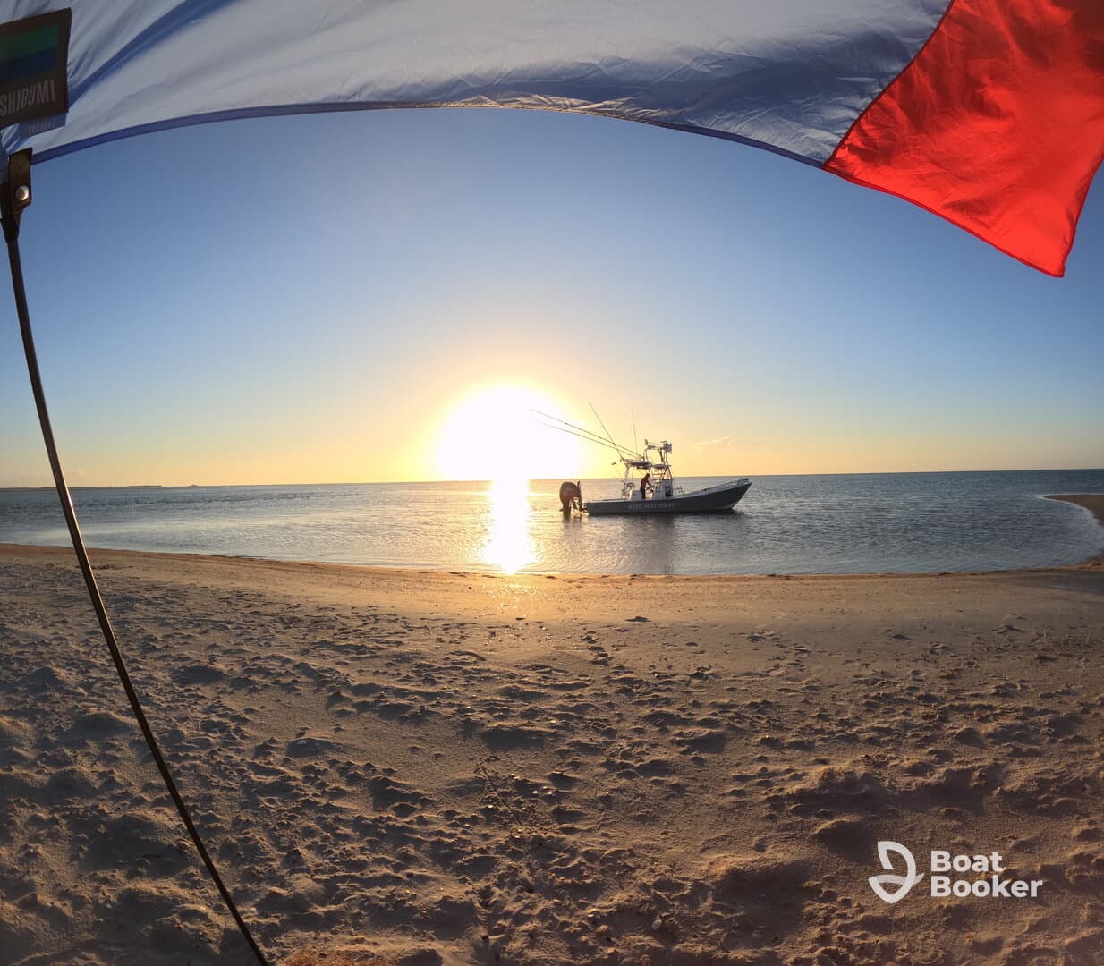 A picturesque sunset scene with a fishing boat anchored near the beach, as a person prepares for a day of fishing — a perfect blend of adventure and relaxation.