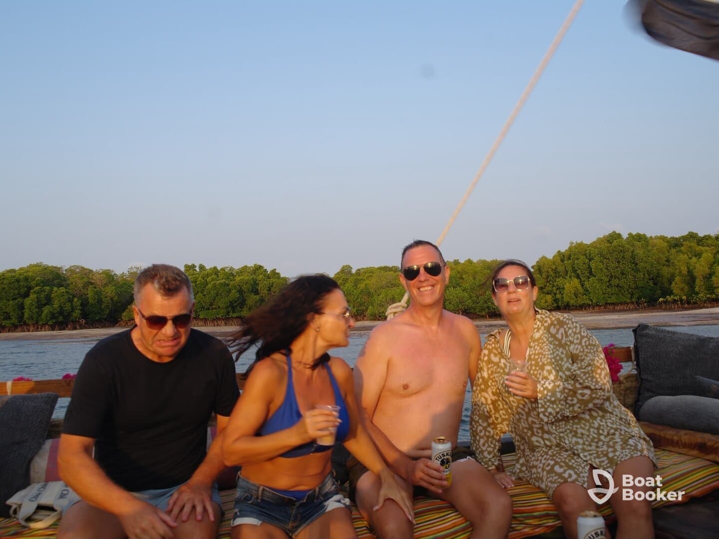 A lively group enjoys drinks and laughter aboard a boat, capturing the essence of a fun-filled day on the water.
