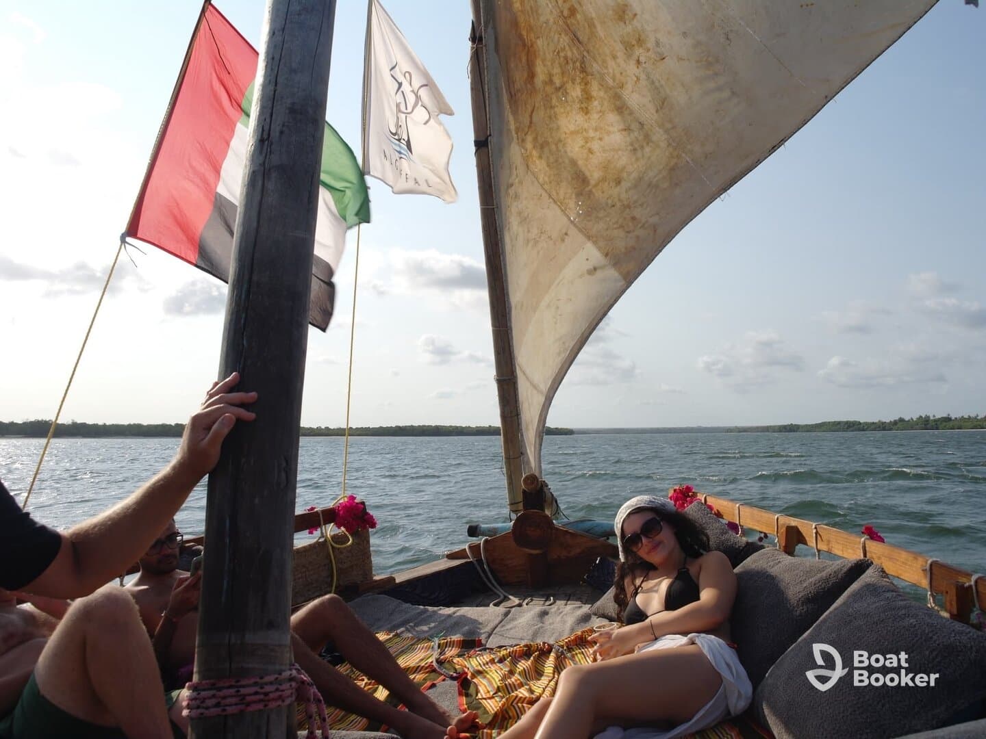Guests enjoy a relaxing day on a traditional sailing boat, soaking up the sun and the beautiful scenery — perfect for a laid-back boating experience.