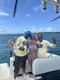 A lively group enjoys a fun day on the water, posing together on a boat with drinks in hand — perfect for memorable adventures and celebrations.