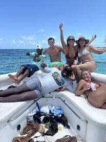 A lively group enjoys a fun day on the boat, celebrating with drinks and laughter under the sun — perfect for unforgettable summer outings.