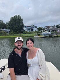 A happy couple poses on a boat, enjoying a scenic day on the water — perfect for romantic outings or memorable adventures.